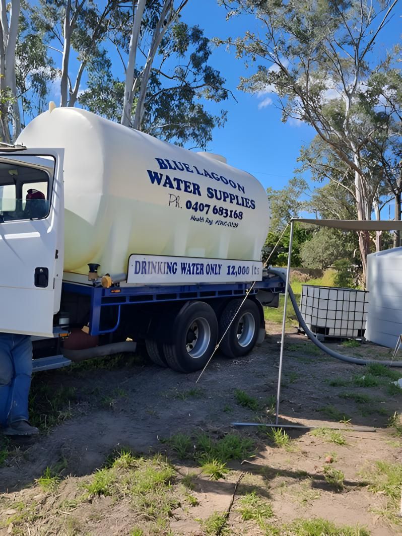 A Water Supply Truck Is Parked In A Dirt Field — Blue Lagoon Water Supplies In Fraser Coast, QLD