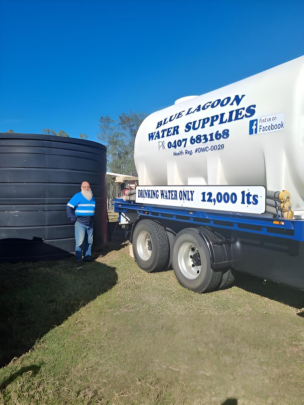 A Man Is Standing Next To A Water Supply Truck — Blue Lagoon Water Supplies In Fraser Coast, QLD