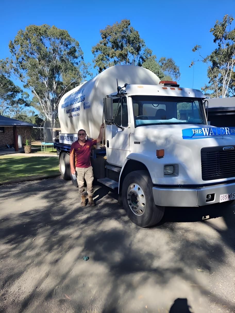 A Man Standing Next To A Water Truck — Blue Lagoon Water Supplies In Fraser Coast, QLD