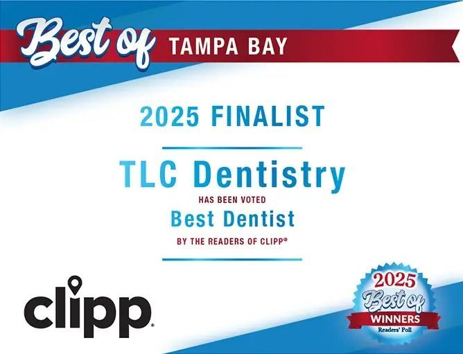 Two women are standing back to back with their arms crossed and smiling.