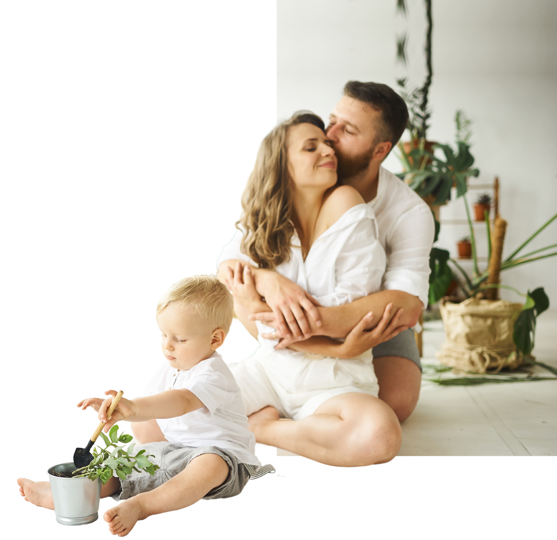 A man and woman are sitting on the floor with a baby.