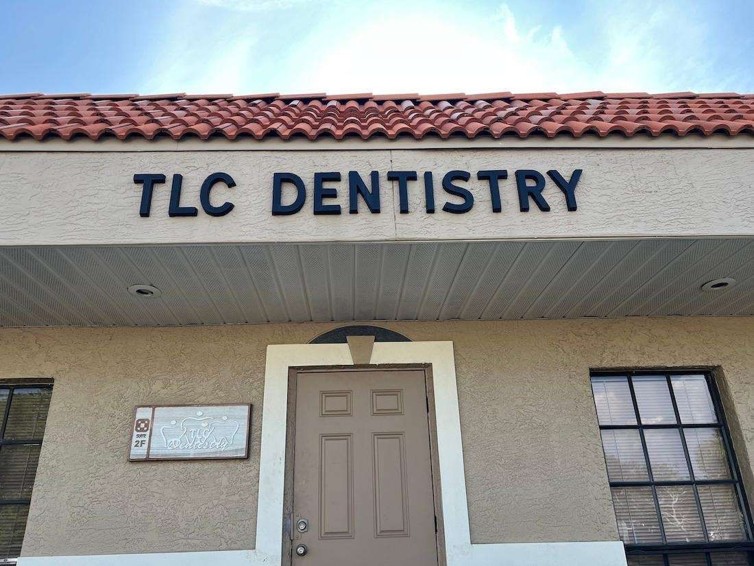 A tlc dentistry building with a brown door