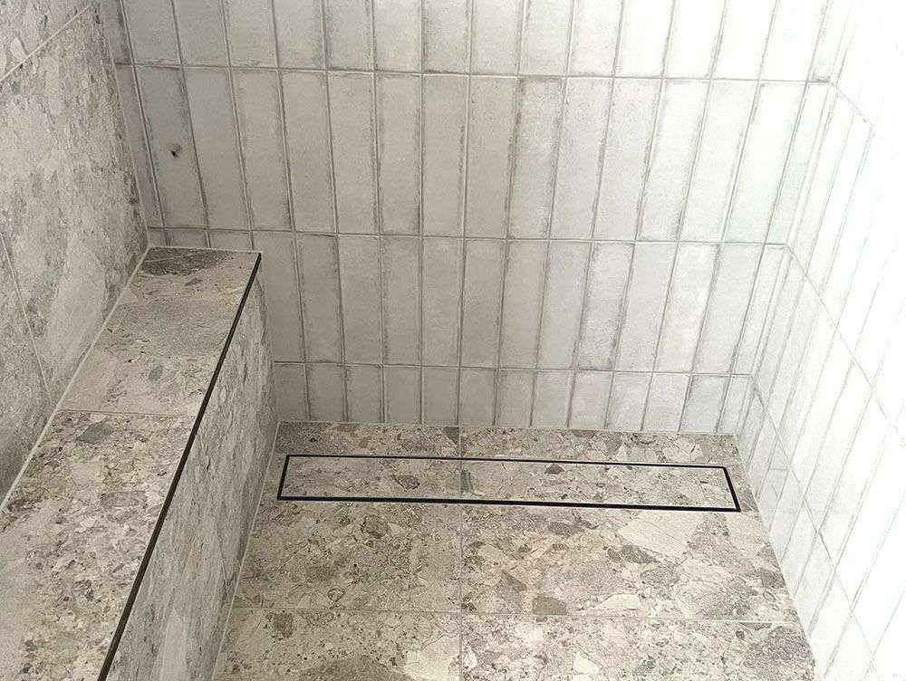 A Bathroom With a Walk in Shower and a Drain — S & S Tiling and Rendering in Bathurst, NSW