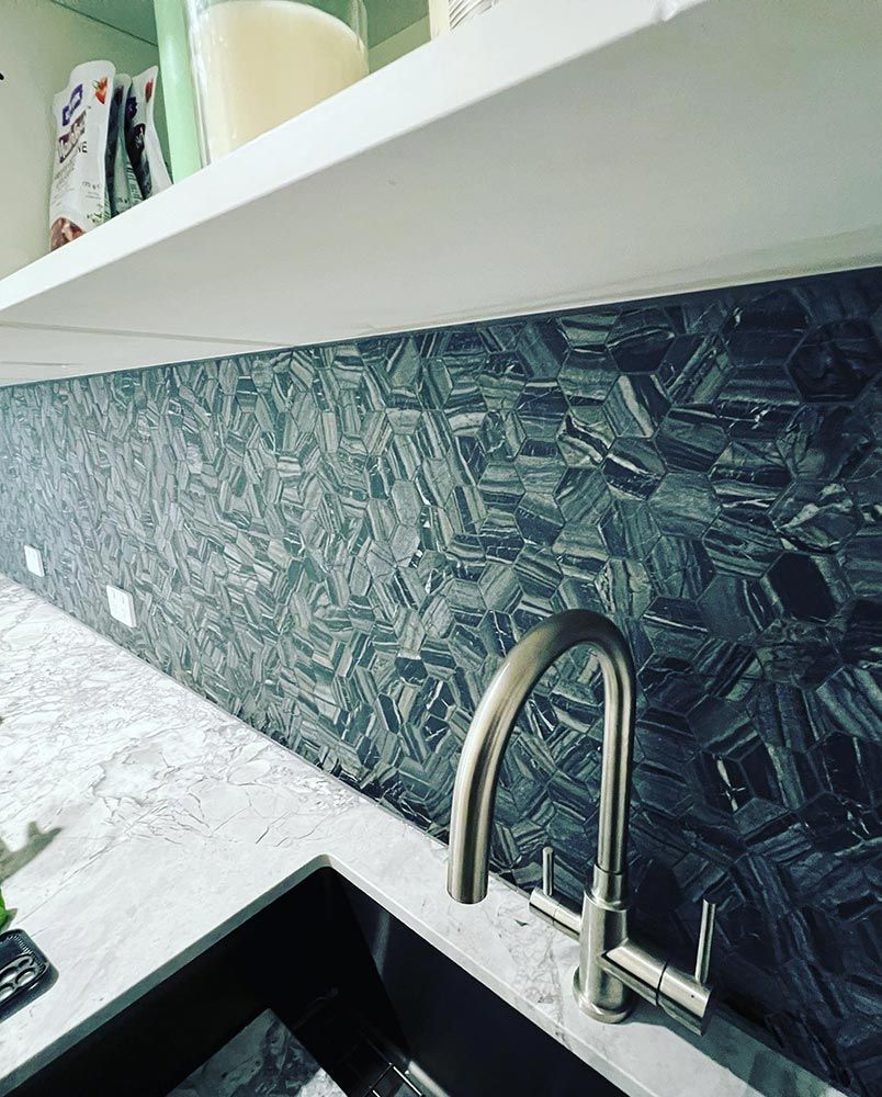 A Kitchen Sink With a Faucet and a Shelf Above It — S & S Tiling and Rendering in Mudgee, NSW