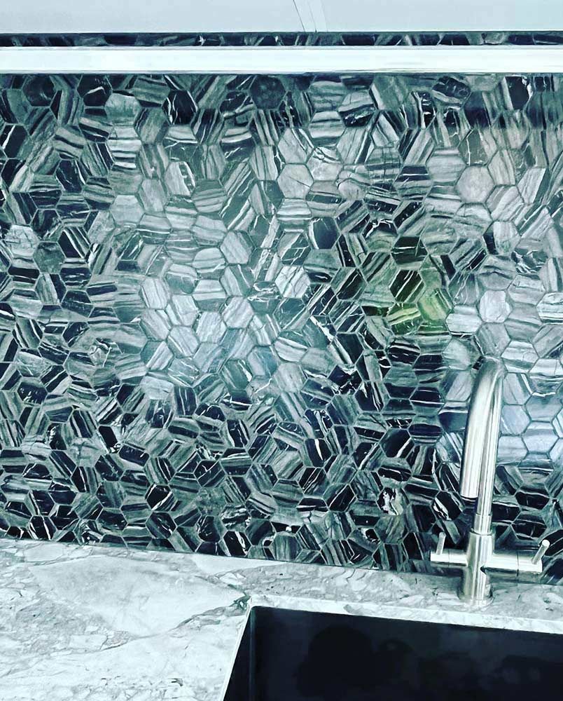 A Kitchen With a Sink and a Tiled Wall Behind It — S & S Tiling and Rendering in Bathurst, NSW