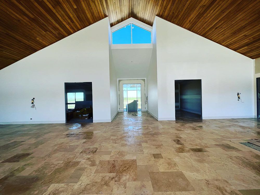 A Large Empty Room With a Vaulted Ceiling — S & S Tiling and Rendering in Bourke, NSW