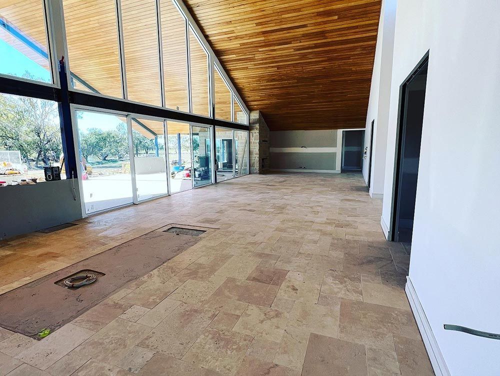 A Large Room With a Lot of Windows and a Wooden Ceiling — S & S Tiling and Rendering in Walgett, NSW