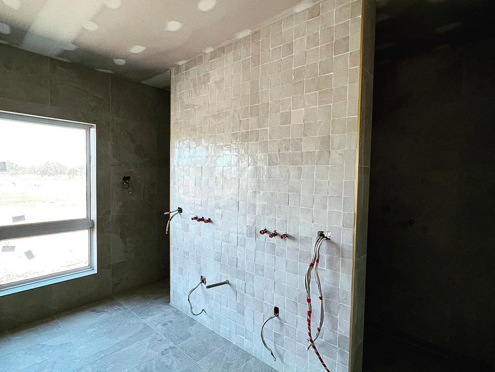 A Room With White Tiles on the Wall and a Window — S & S Tiling and Rendering in Bourke, NSW