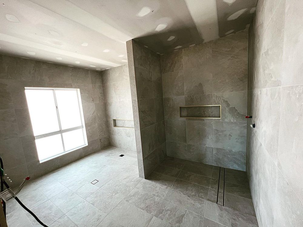 A Bathroom With a Walk-in Shower and a Window — S & S Tiling and Rendering in Geurie, NSW