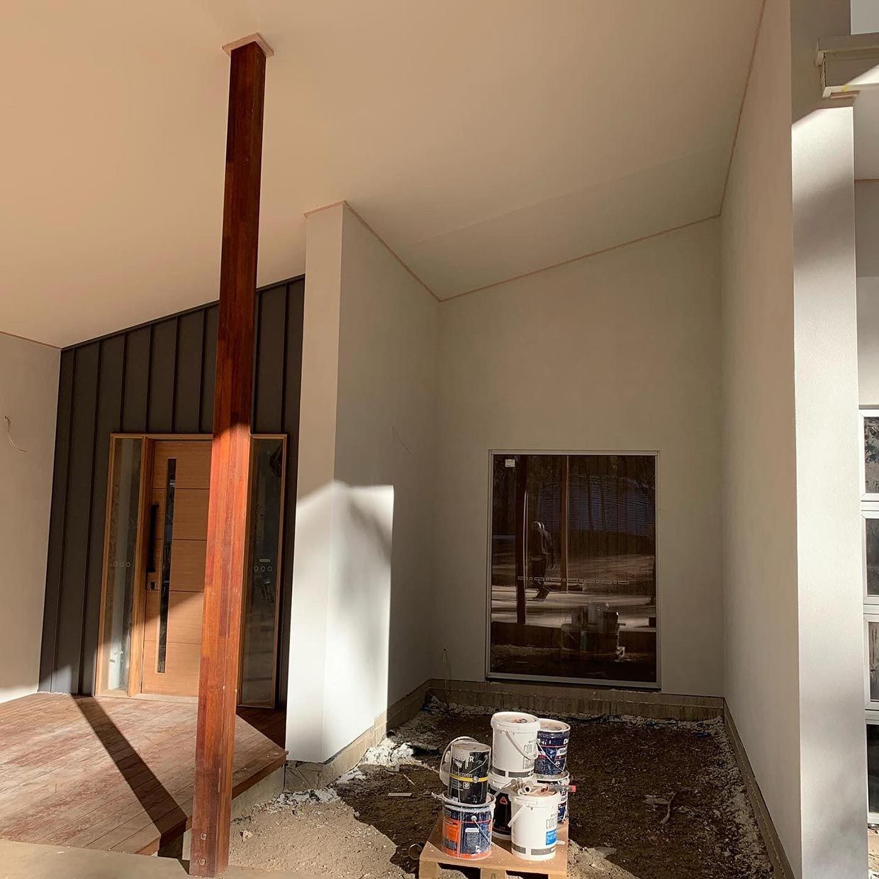 A Building Under Construction With a Wooden Pole in the Middle of It — S & S Tiling and Rendering in Mudgee, NSW