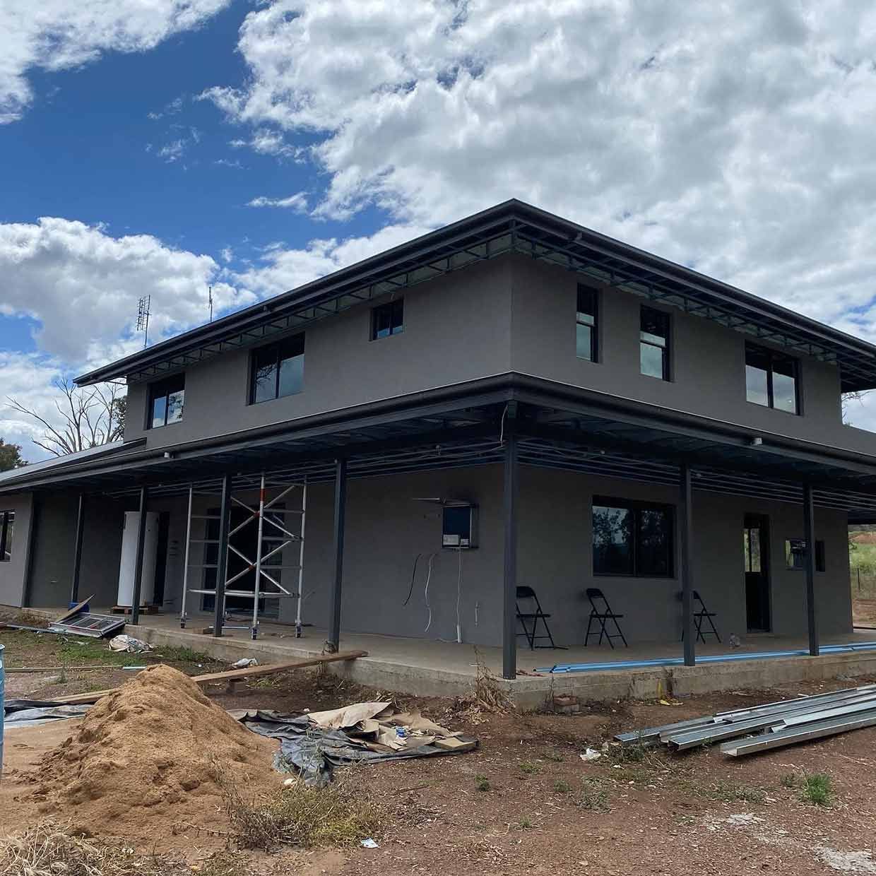 A Large House is Being Built in the Middle of a Dirt Field — S & S Tiling and Rendering in Bathurst, NSW