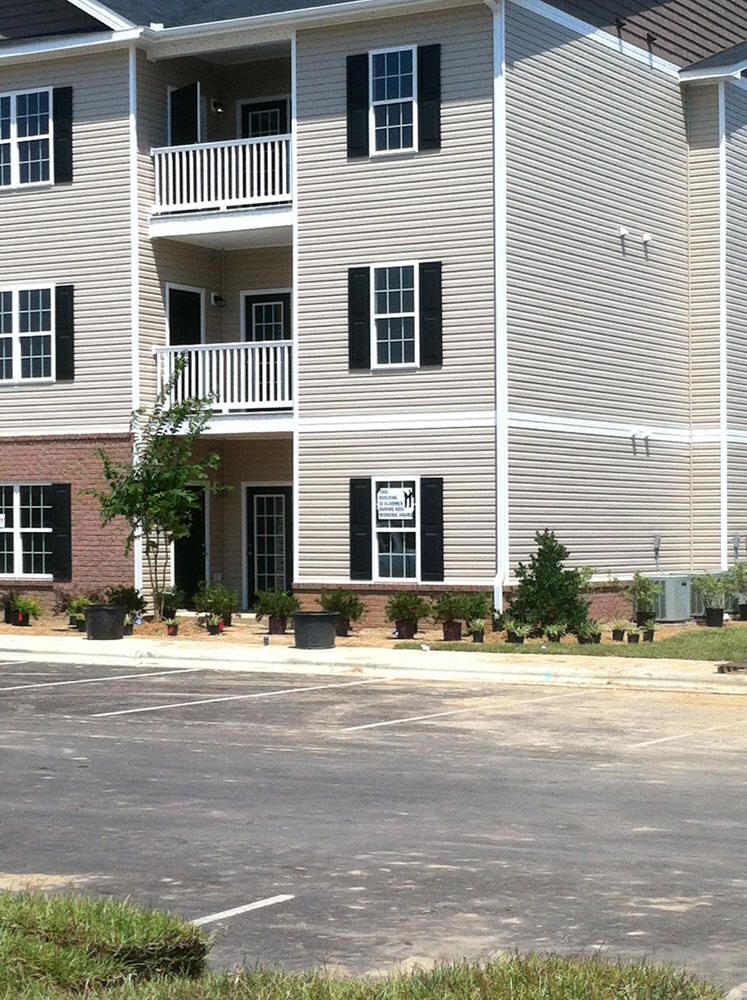 A building with a lot of windows and black shutters