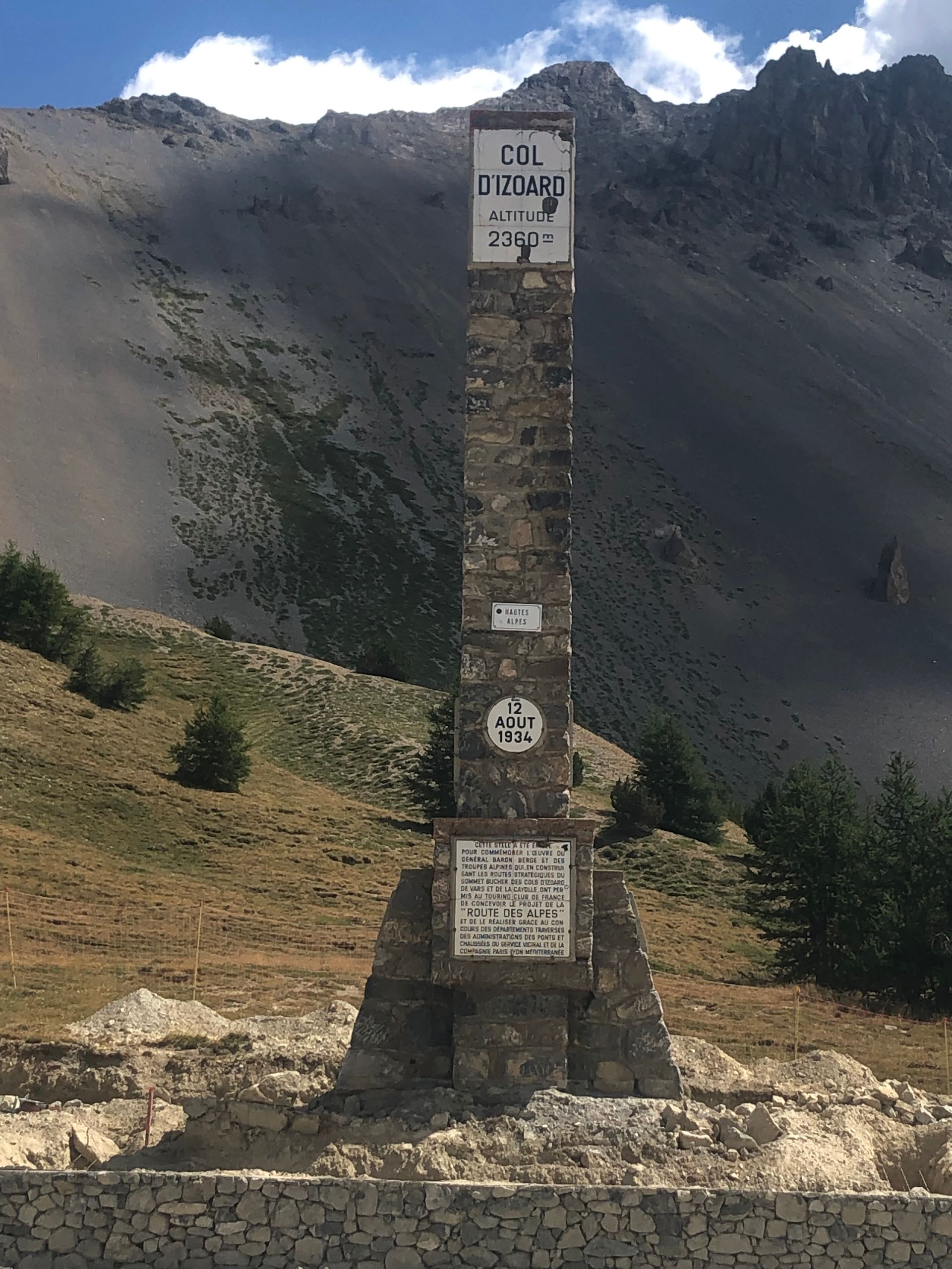 A stone pillar with a sign that says tdv on it