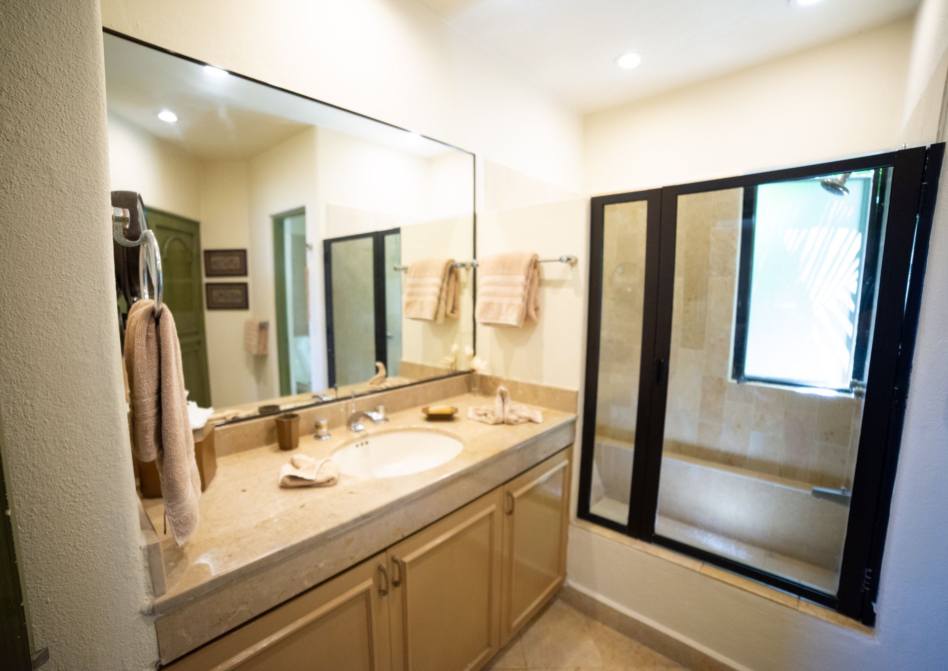 a living room with a sliding glass door leading to a balcony .
