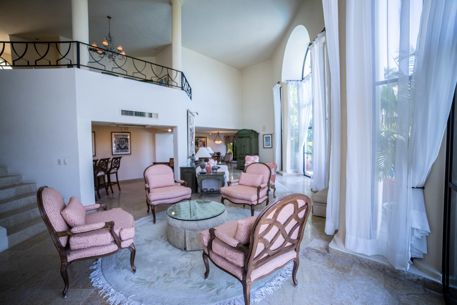 A living room filled with furniture and a large window.