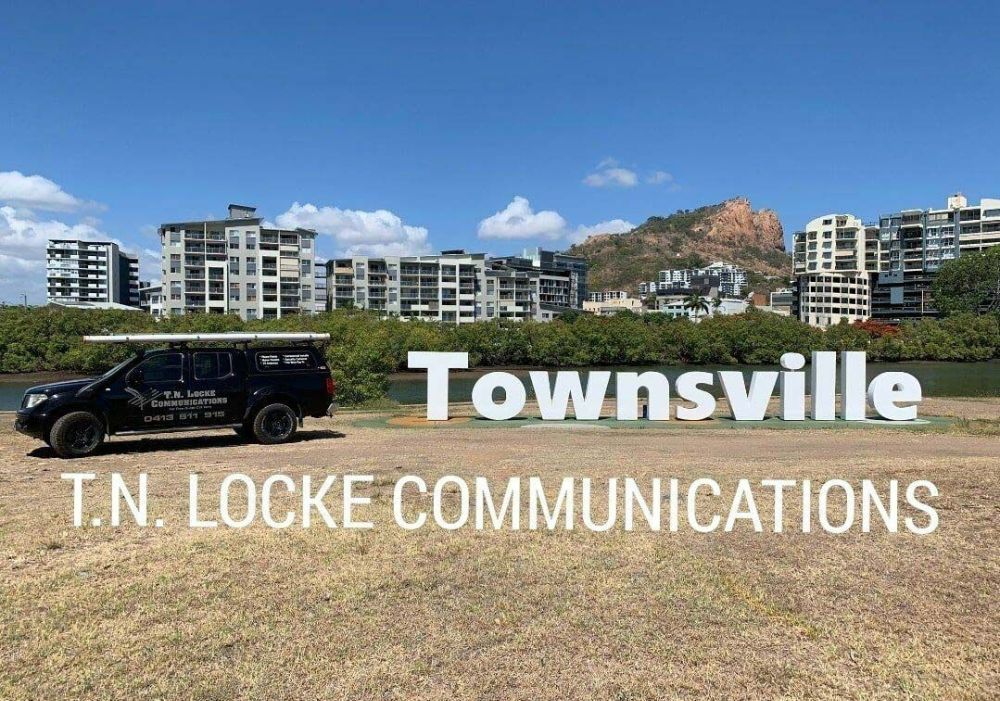 A Car Is Parked in Front of A Sign that Says Townsville — T.N. Locke Communications In Kirwan, QLD
