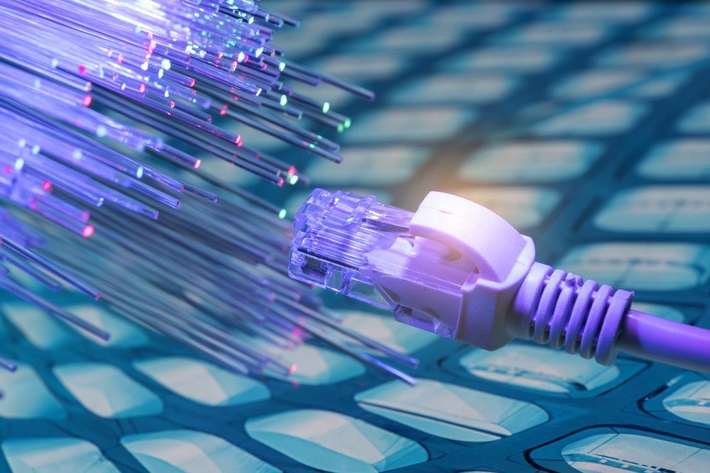 A Purple Ethernet Cable Is Connected to A Purple Optical Fiber Cable — T.N. Locke Communications In Kirwan, QLD