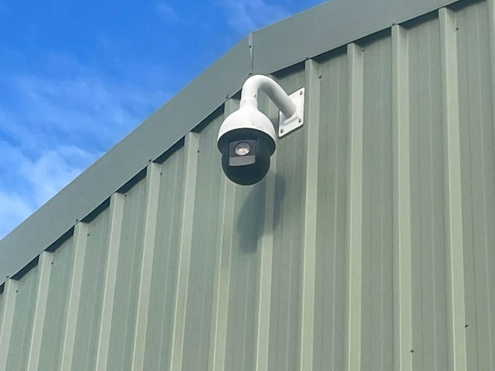 A Security Camera Is Mounted on The Side of A Building — T.N. Locke Communications In Kirwan, QLD