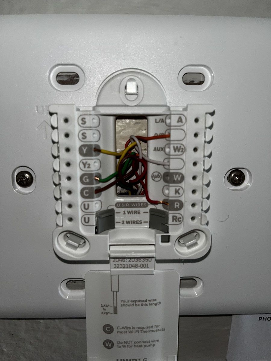 Thermostat wiring: wires connected to terminals labeled with letters (Y, G, C, W, etc.).