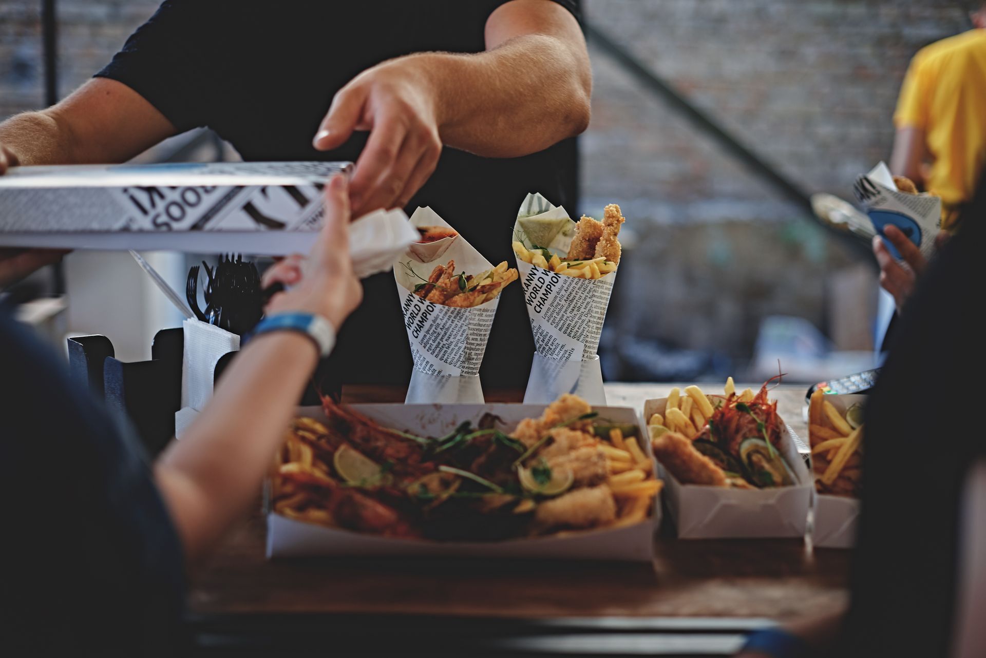 A man is serving food to a woman at a food stand.