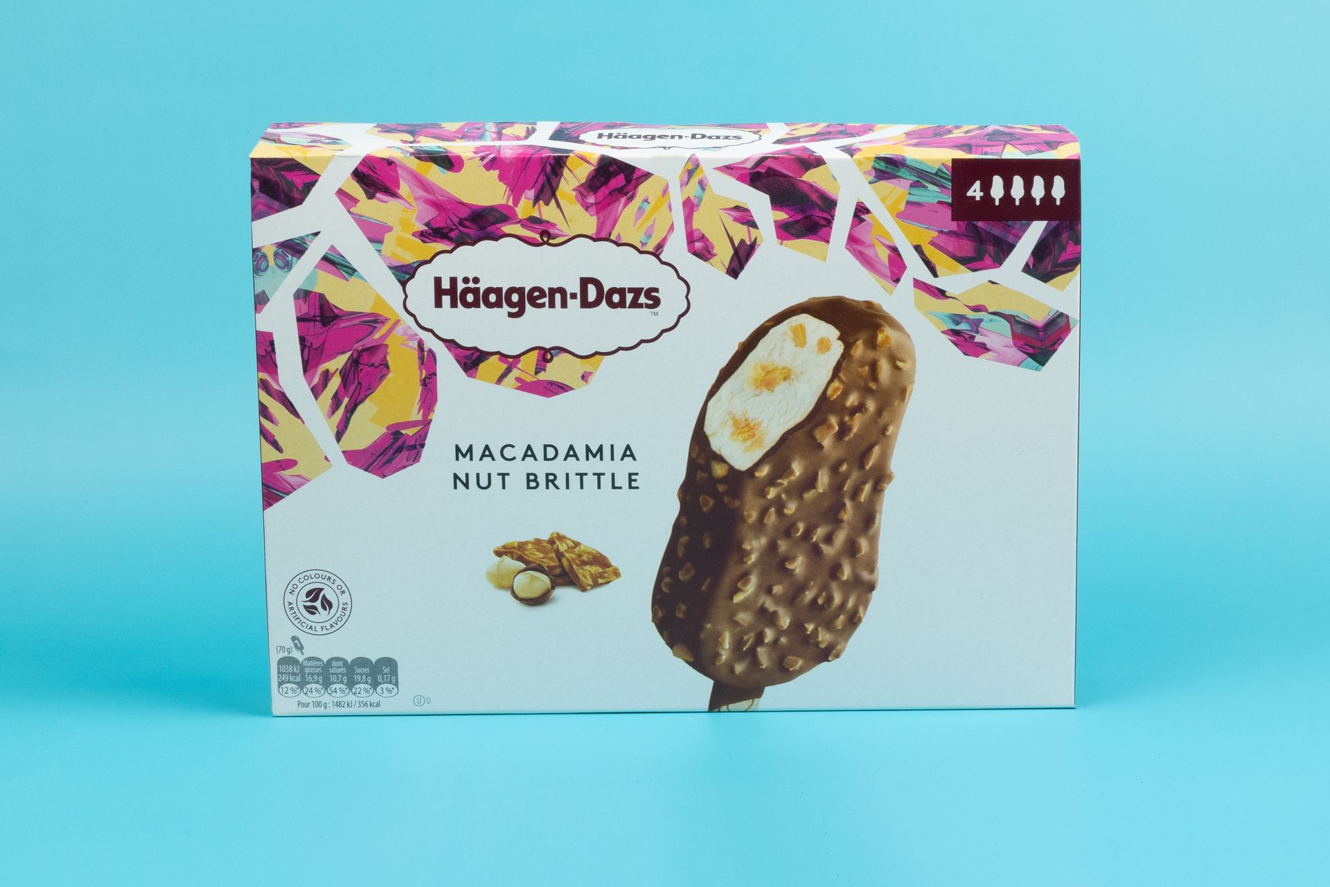 A box of macadamia nut brittle ice cream bars on a blue background.