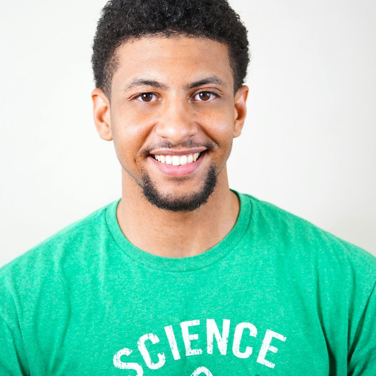 A man wearing a green shirt that says science on it