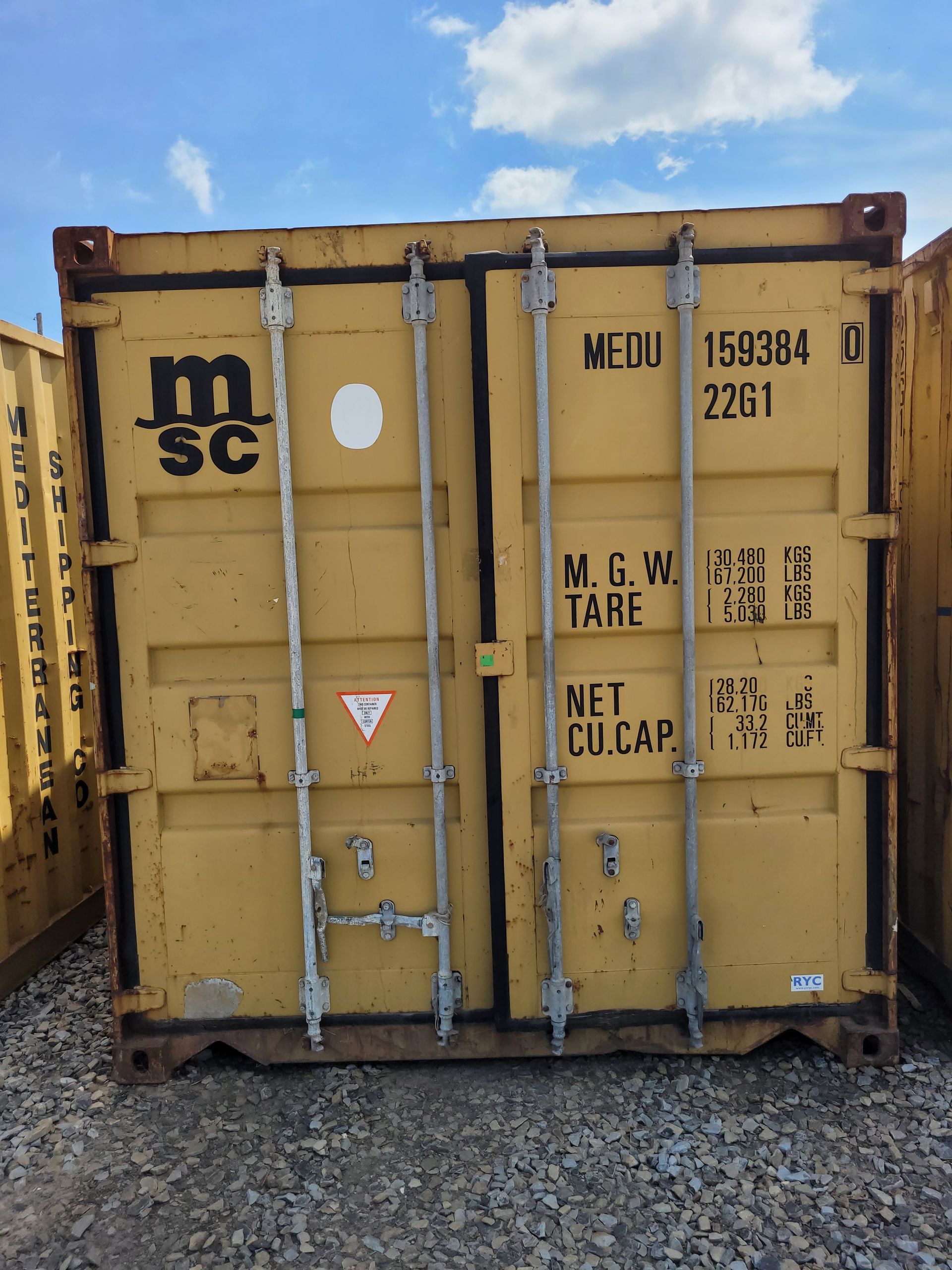 A yellow shipping container that says msc on it