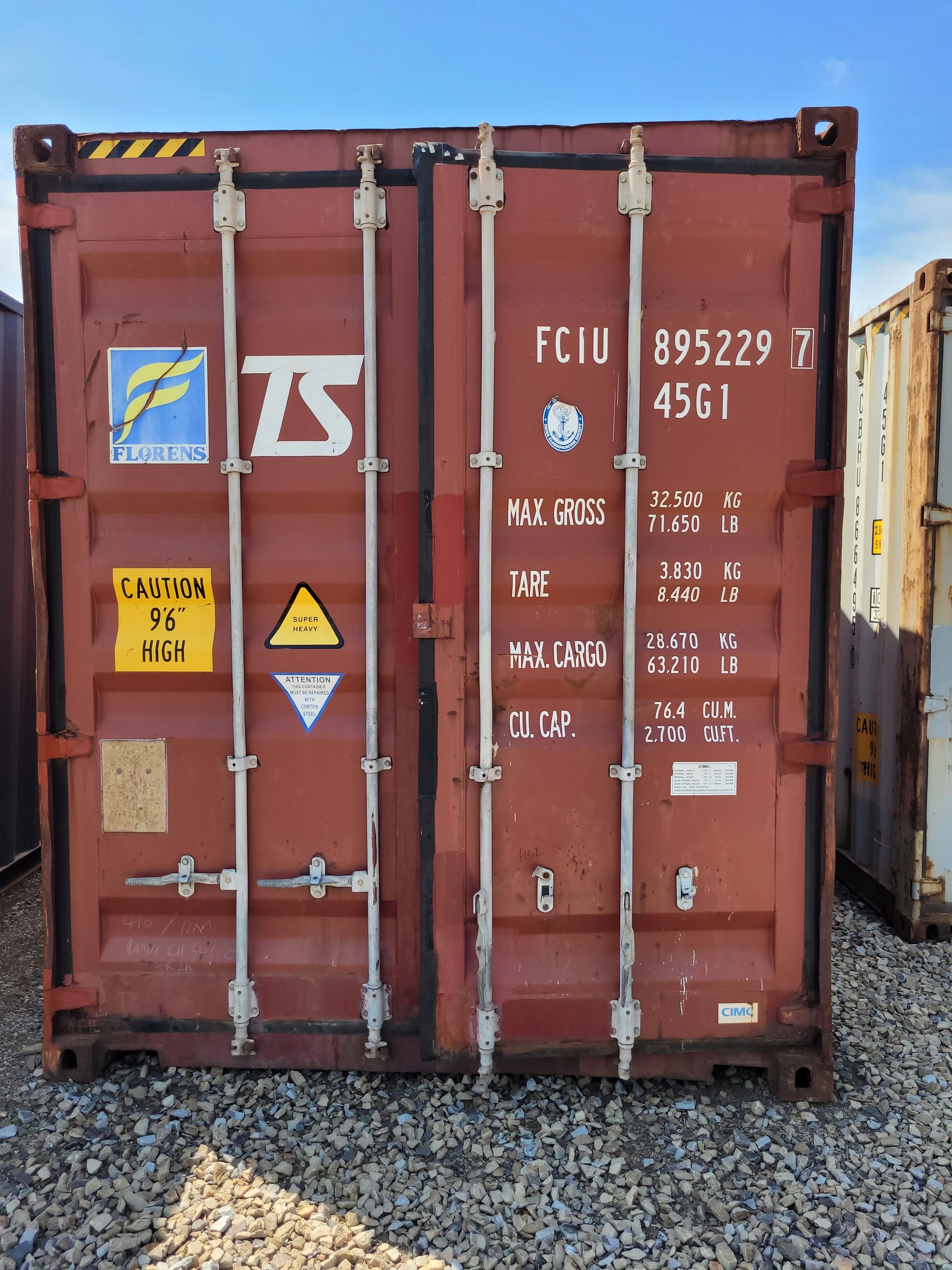 A red shipping container with the letter t on it