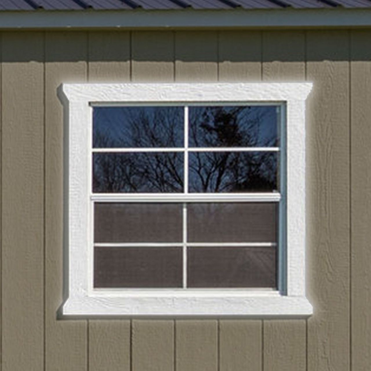 A window on the side of a building with a white trim