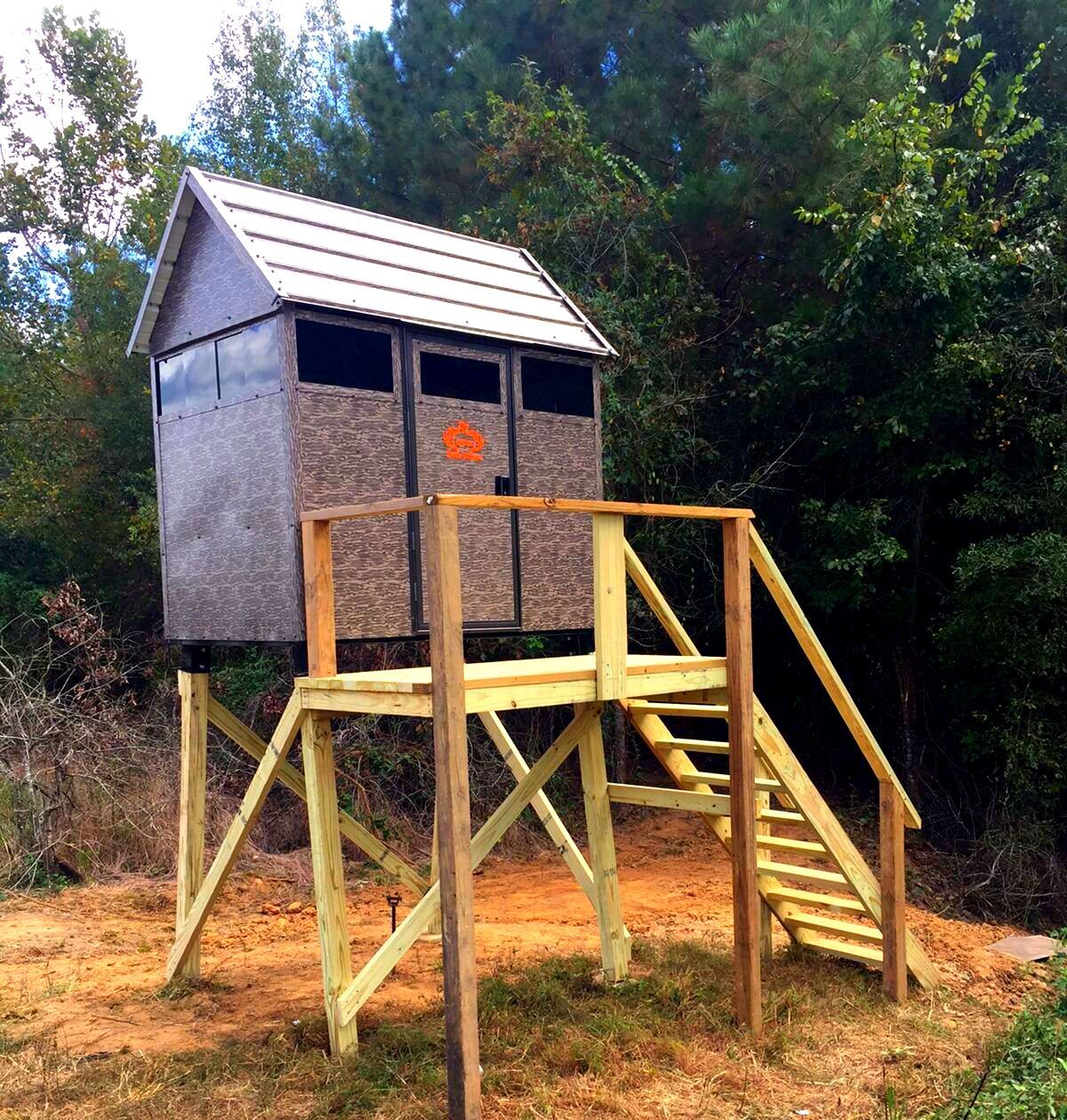 A small wooden shed with stairs leading up to it