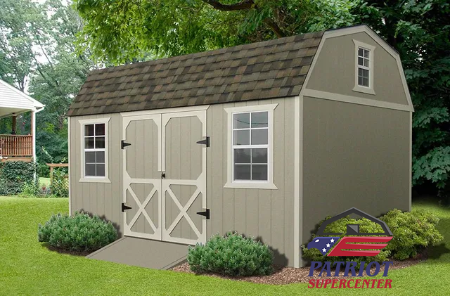 A barn shed with a ramp is sitting on top of a lush green lawn.