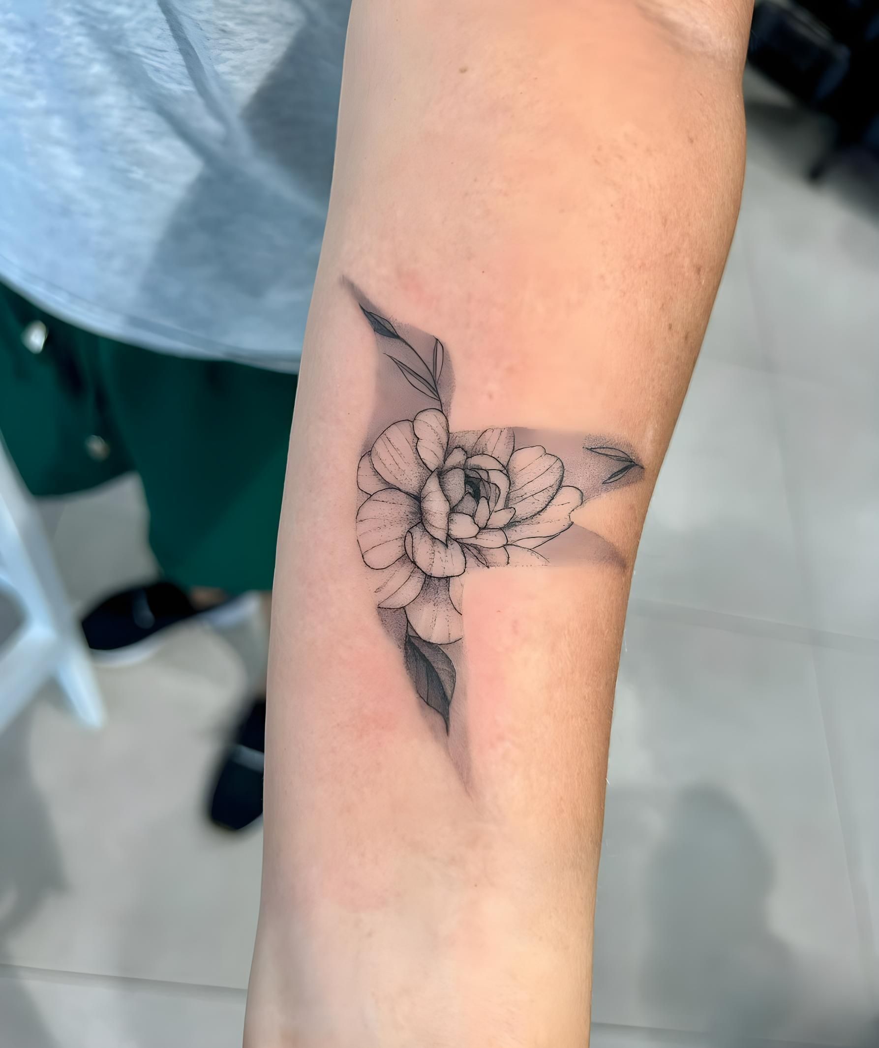 Tattoo Of A Black And White Flower And Leaves On A Person's Forearm  — Tattoo Inc Studio In Broadbeach, QLD