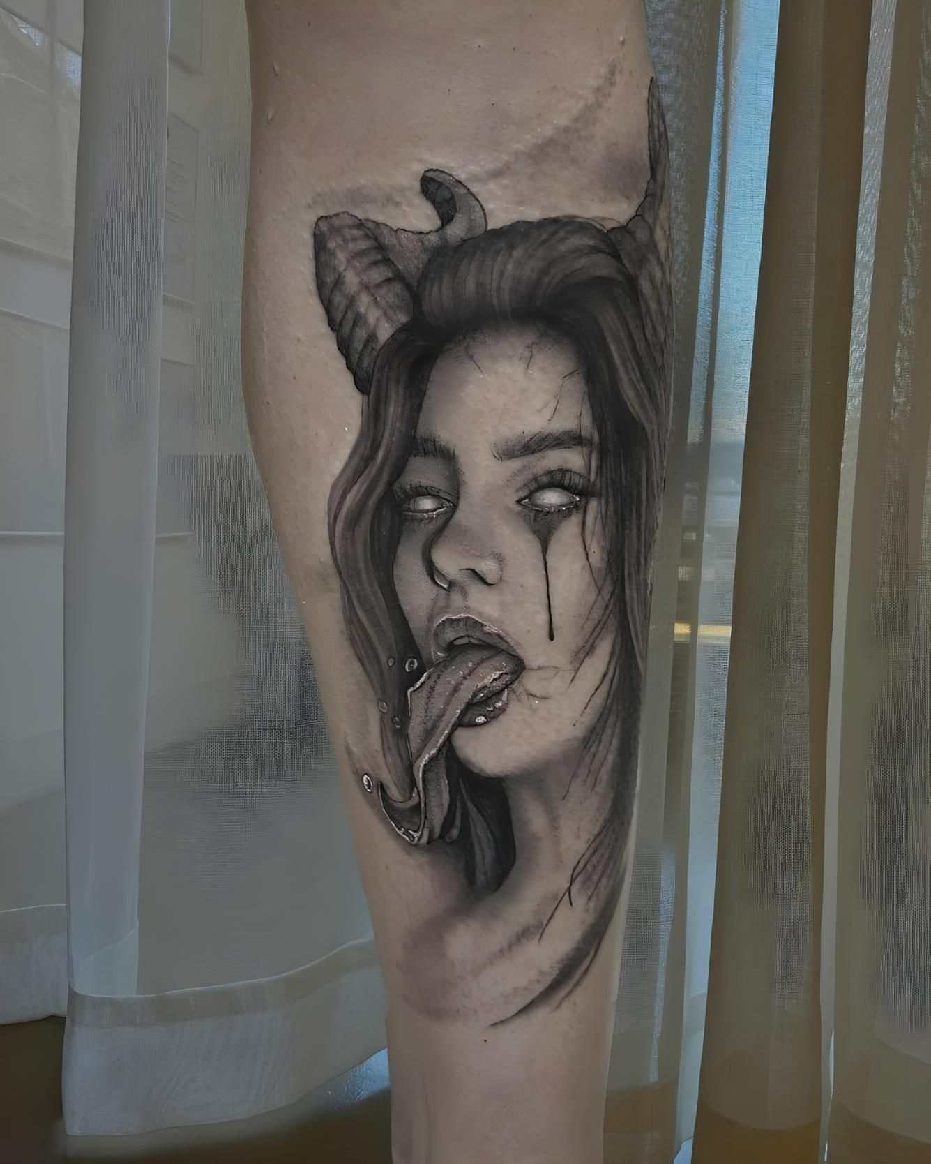 Tattoo Of A Woman With Horns, White Eyes, And A Long, Forked Tongue — Tattoo Inc Studio in Surfers Paradise, QLD