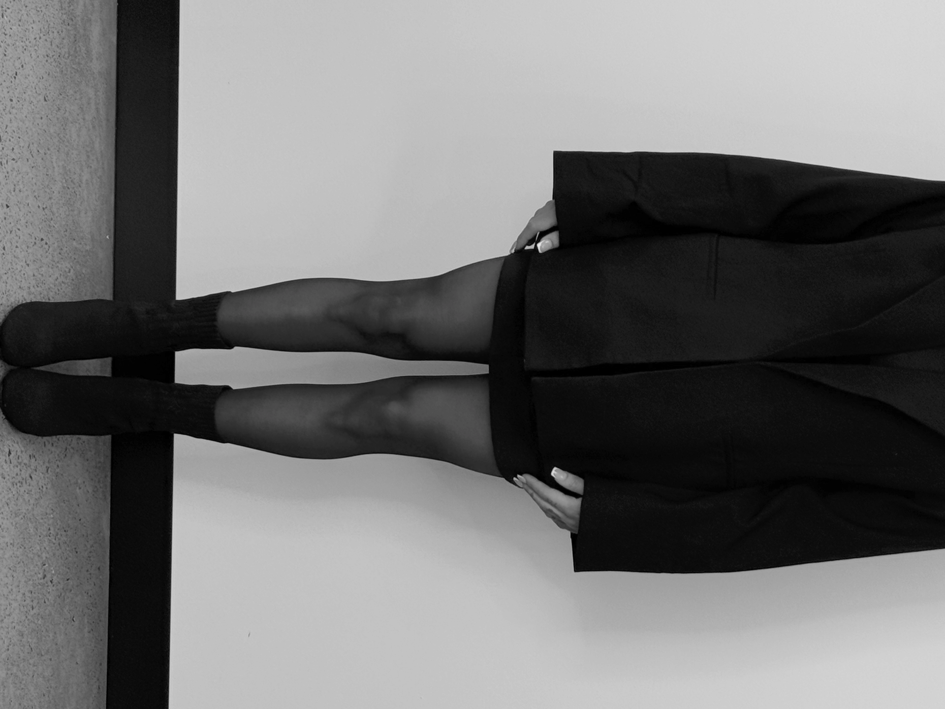 Woman in black top drawing at a tattoo station, using a tablet and stylus. A light ring and ink bottles are visible — Tattoo Inc Studio In Broadbeach, QLD