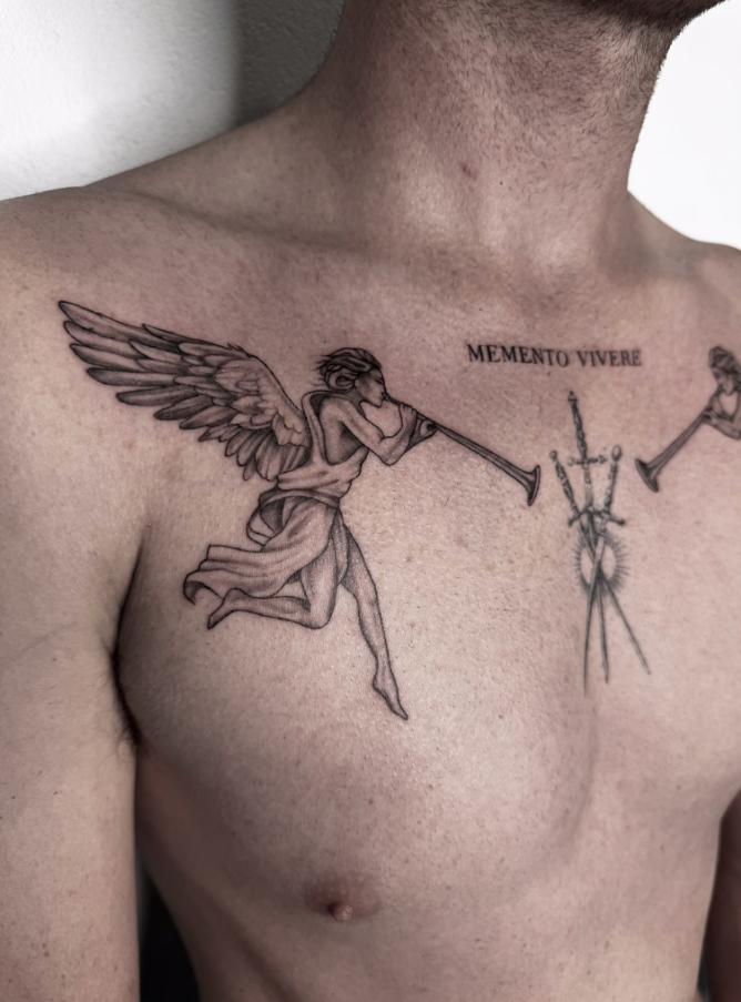 Tattoo of an eye with a starburst, on a person's arm. Also, a crab and UFO tattoos are visible.