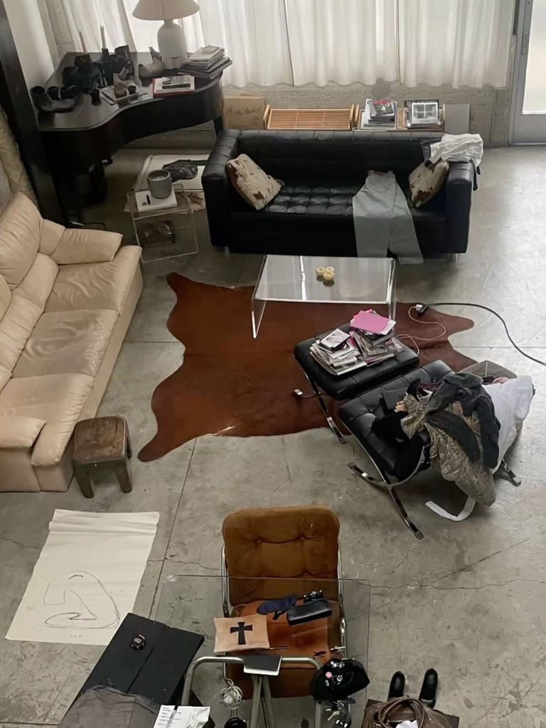 Overhead view of a living room with various furniture, a rug, and personal belongings.