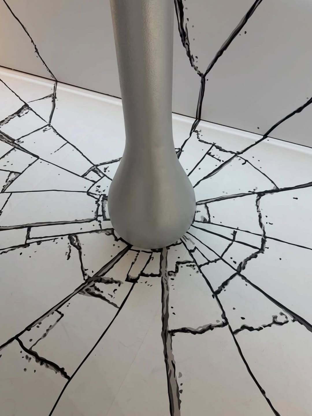 Silver column piercing white surface with black cracks radiating outward — Tattoo Inc Studio In Broadbeach, QLD