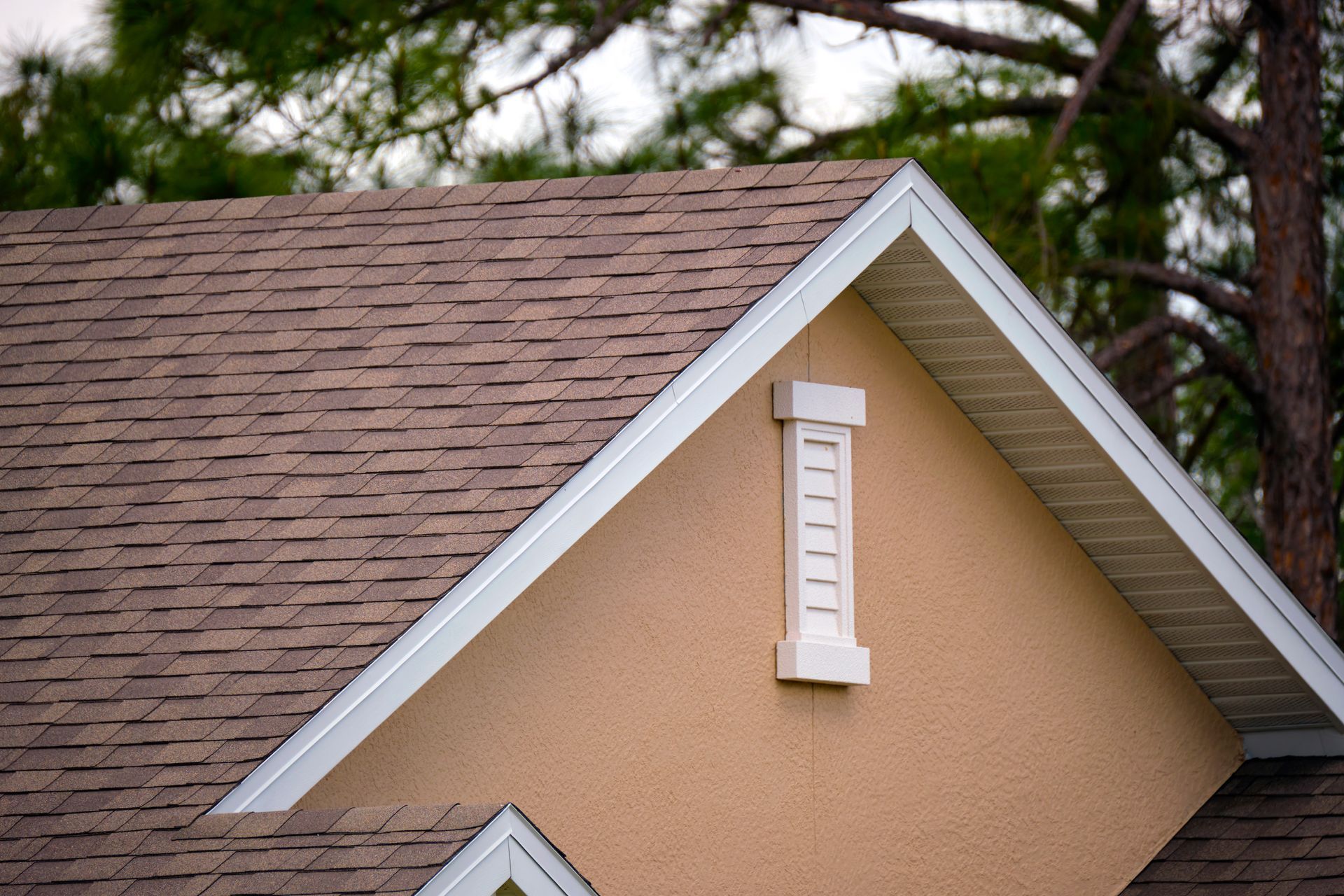 A man is working on the roof of a house.