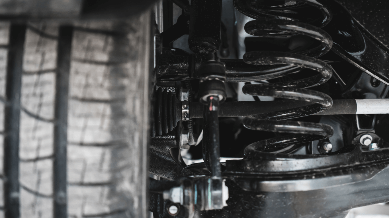 a mechanic repairing a suspension