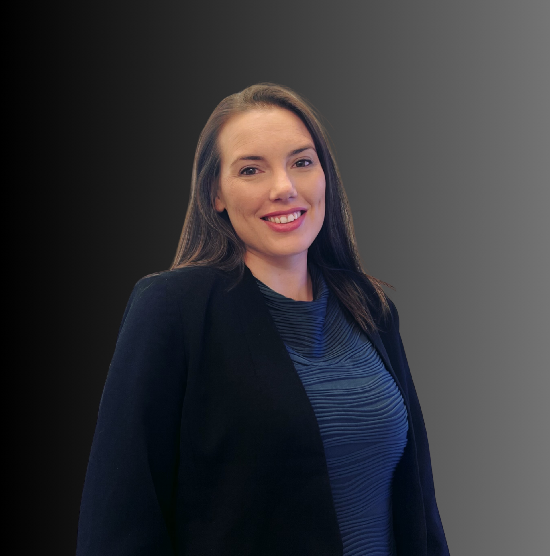 Woman in a white button-down shirt smiles, wearing a pearl necklace, against a gray gradient background.