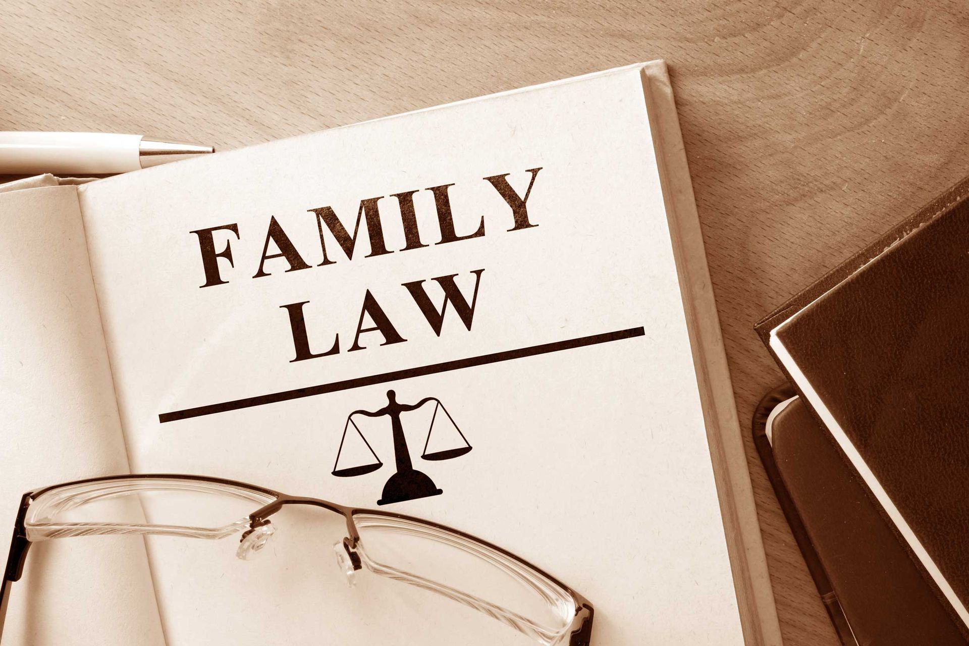 An open book with the words “family law” and glasses on top of it.