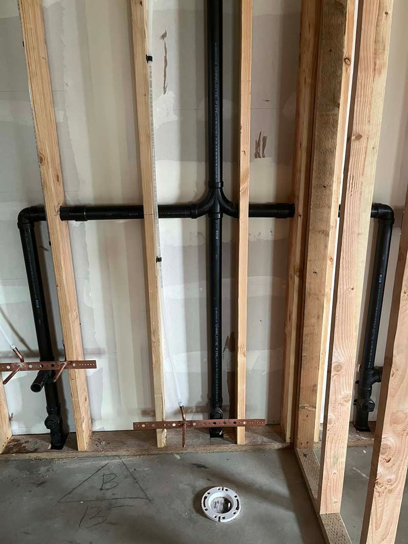 Hand pressing a button on a gray and white boiler. Digital display showing numbers.