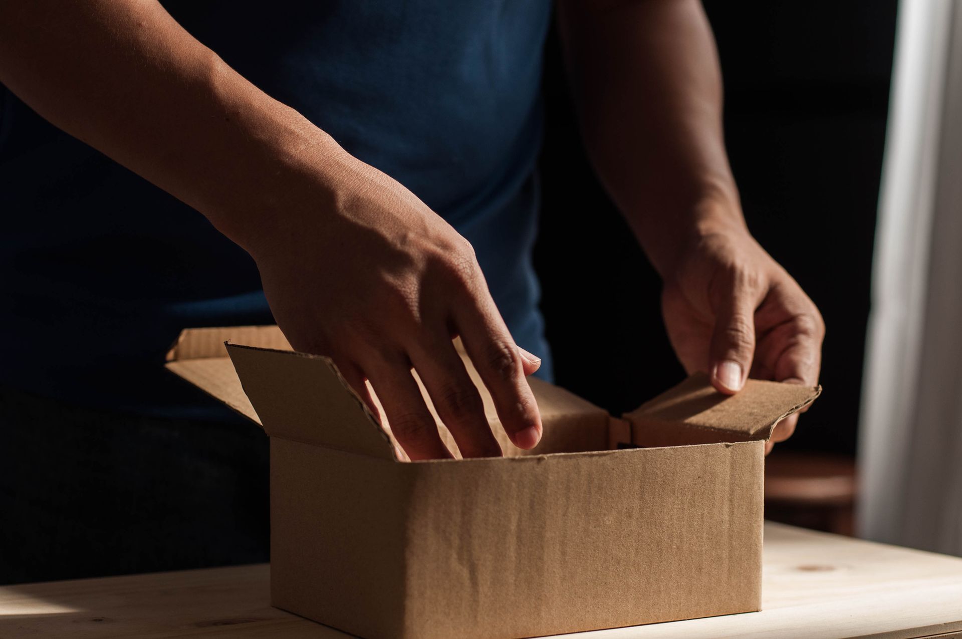 Unpacking Man Hand - Lubbock, TX - Byron Cowling Moving & Storage