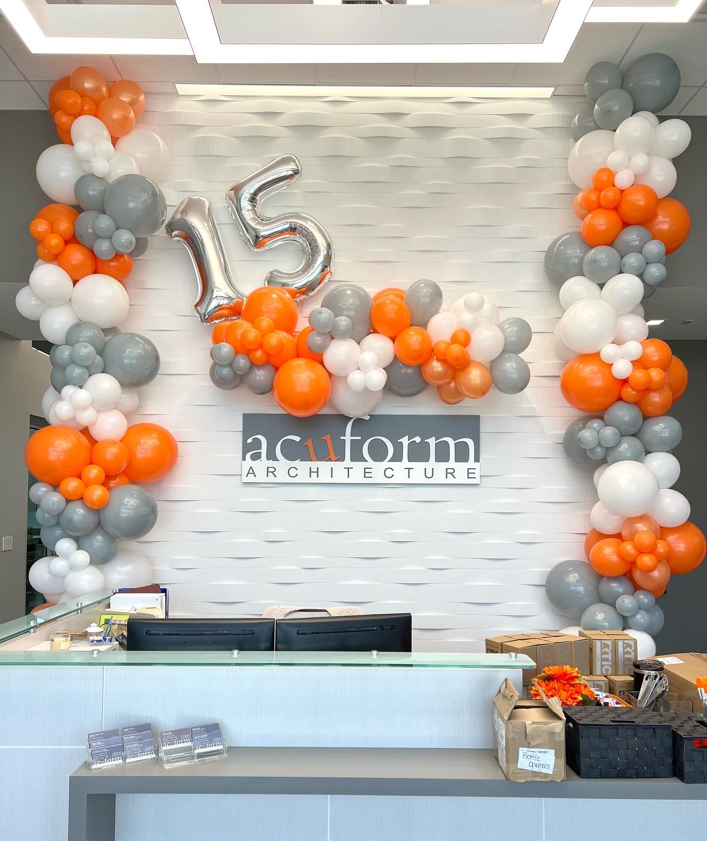 a reception area decorated with balloons and the number 15