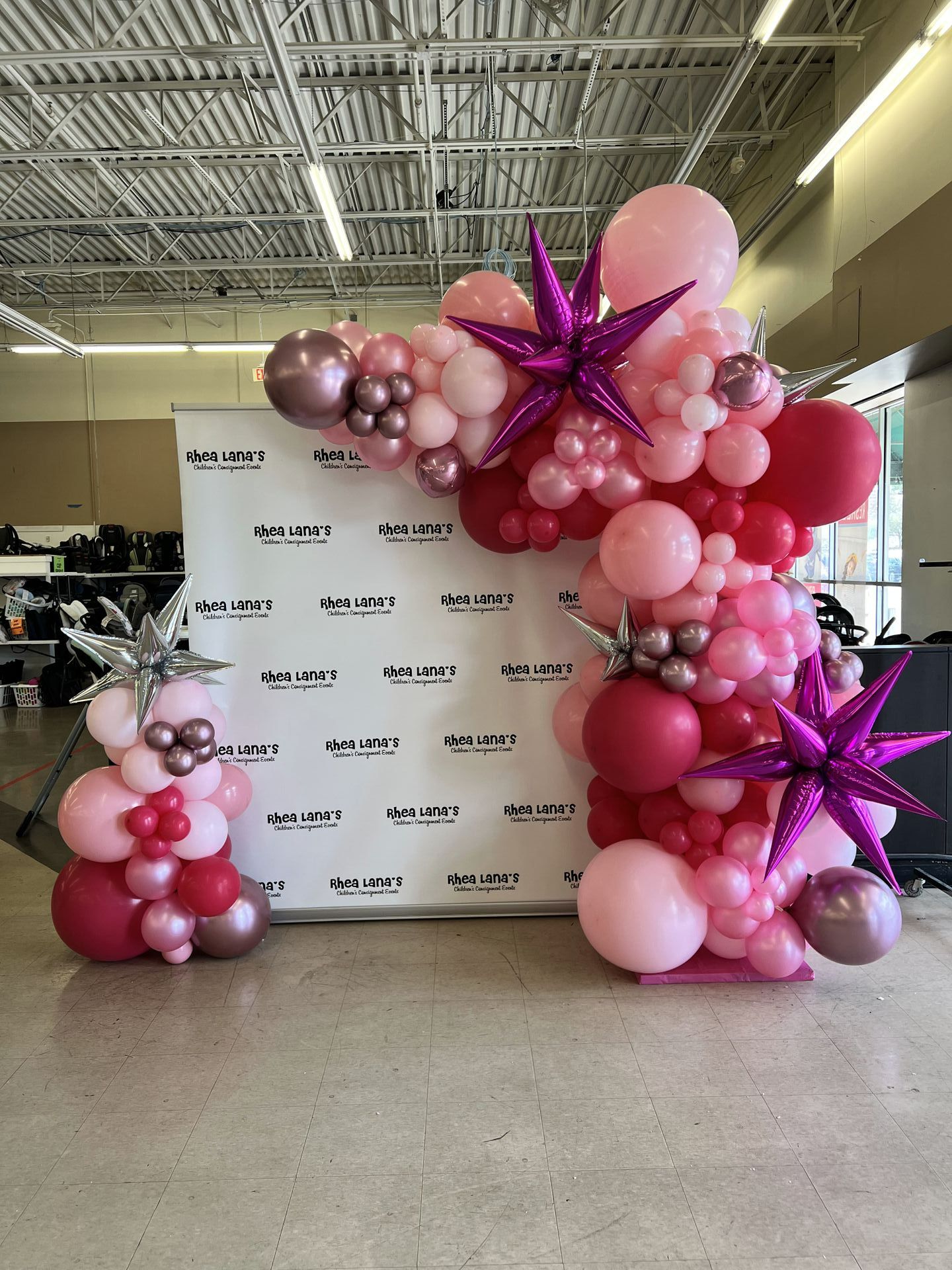 a bunch of pink and purple balloons are sitting on the floor in a room