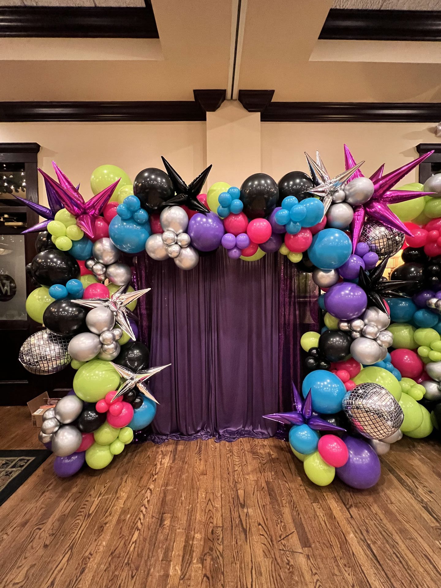 Colorful balloon arch with stars and disco balls