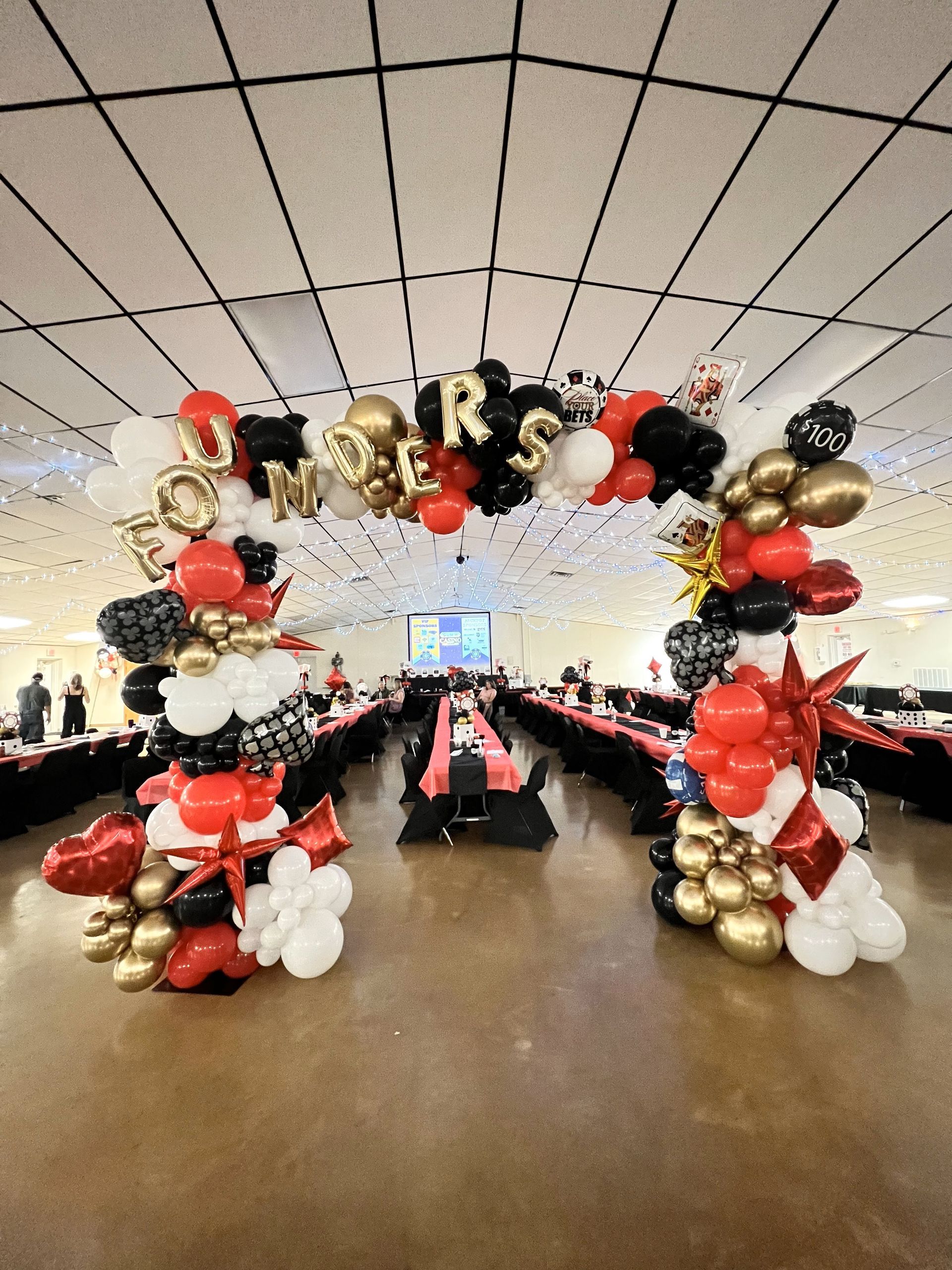 a large room filled with balloons and tables