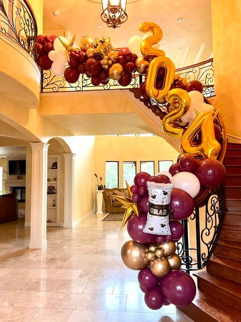 A staircase decorated with balloons for a graduation party