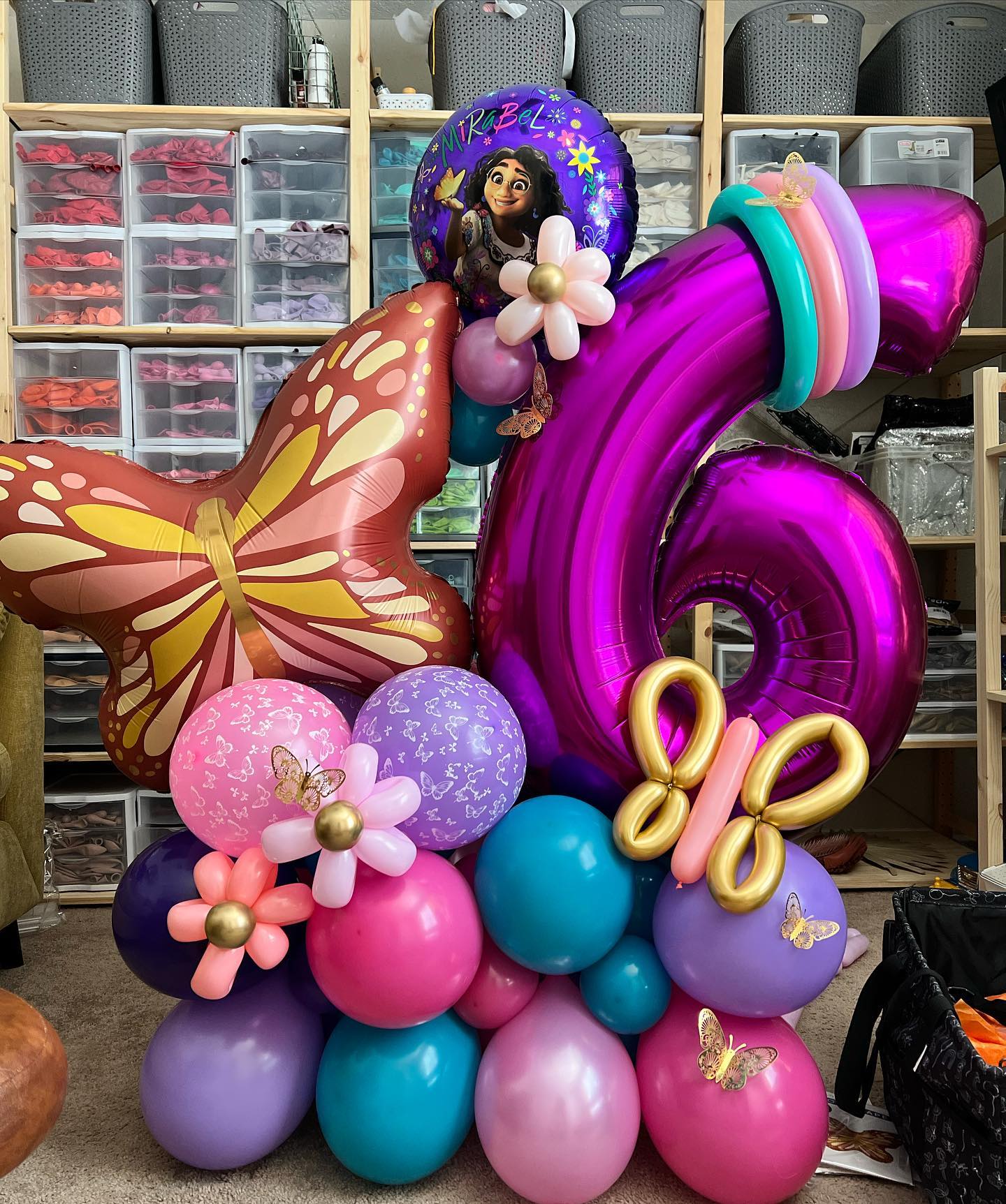 a bunch of balloons are stacked on top of each other in a room