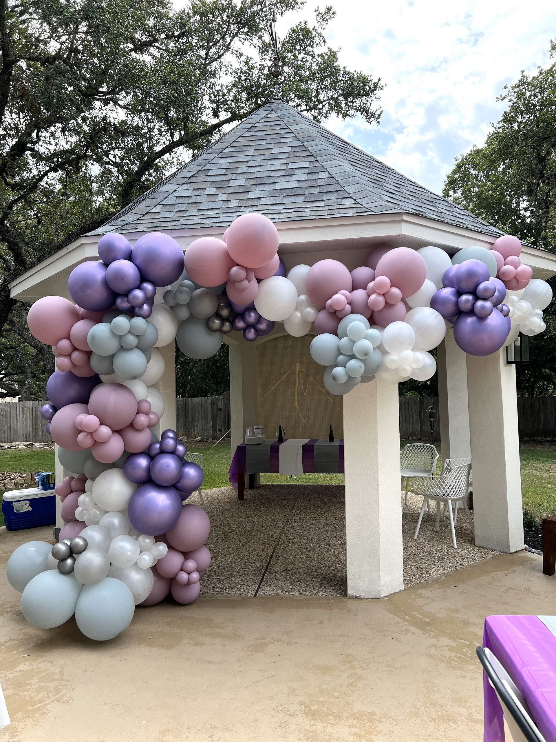 a gazebo is decorated with balloons for a birthday party